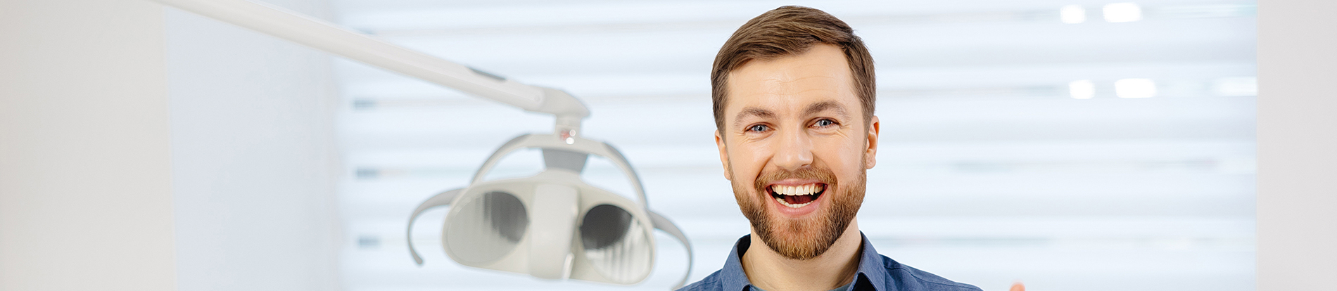 A well-lit reception area with a desk, computer monitor, and potted plant.